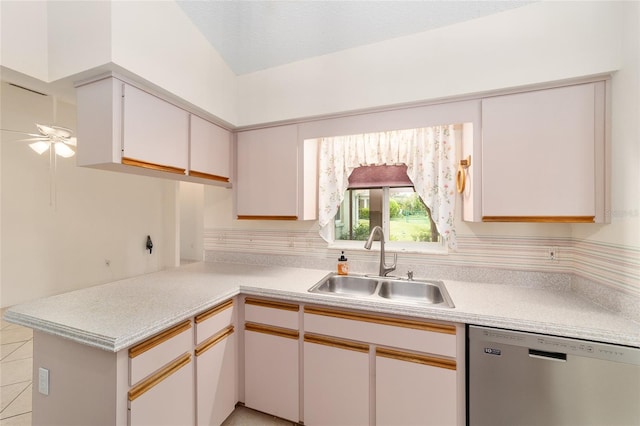 kitchen with dishwasher, sink, white cabinets, lofted ceiling, and ceiling fan