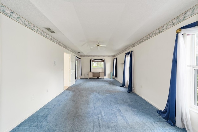 empty room featuring ceiling fan and carpet