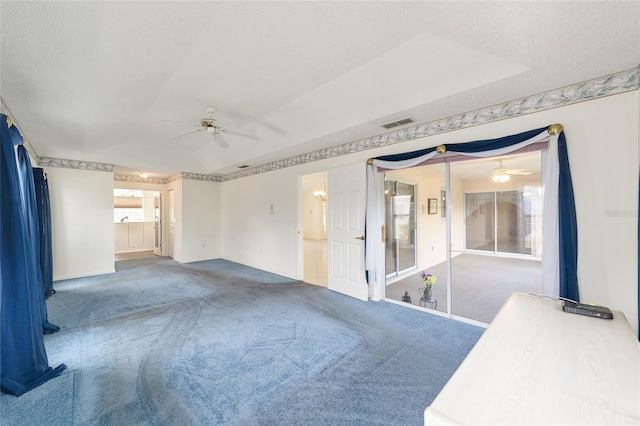 unfurnished room featuring a textured ceiling, carpet, and ceiling fan