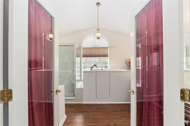 bathroom with lofted ceiling, independent shower and bath, and hardwood / wood-style flooring