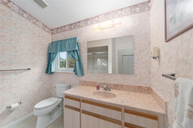 bathroom featuring tile patterned flooring, a textured ceiling, an enclosed shower, vanity, and toilet