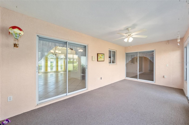 unfurnished room with ceiling fan and carpet floors