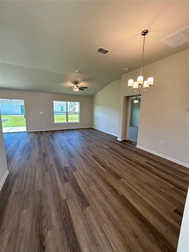 interior space with ceiling fan with notable chandelier, dark wood-style flooring, visible vents, and baseboards