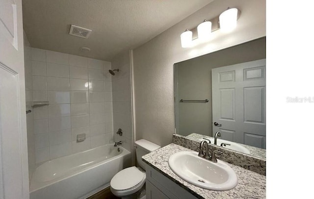 bathroom featuring visible vents, toilet, shower / tub combination, a textured ceiling, and vanity