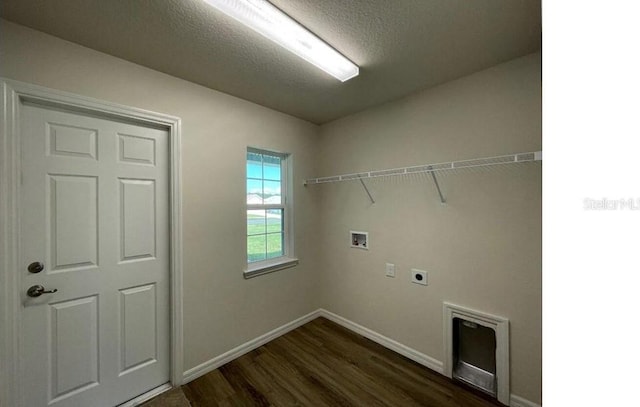 clothes washing area featuring dark wood-style floors, hookup for a washing machine, electric dryer hookup, laundry area, and baseboards