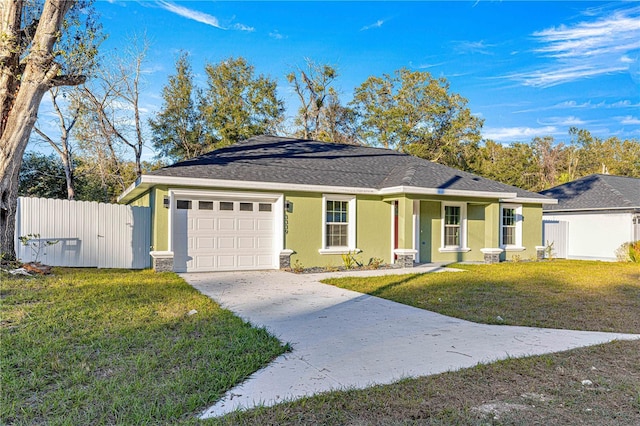 single story home featuring a garage and a front lawn