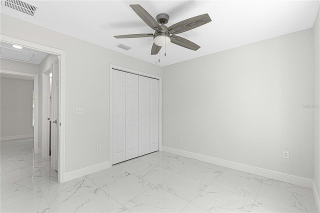 unfurnished bedroom with ceiling fan and a closet