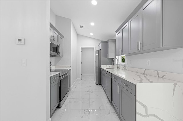 kitchen with appliances with stainless steel finishes and gray cabinets