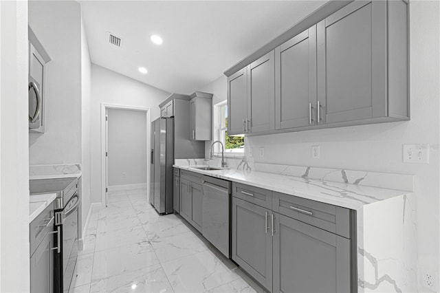 kitchen featuring sink, appliances with stainless steel finishes, and gray cabinets