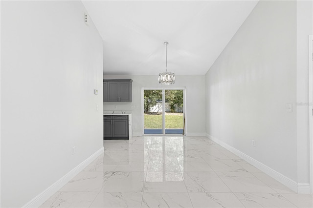 unfurnished dining area featuring an inviting chandelier