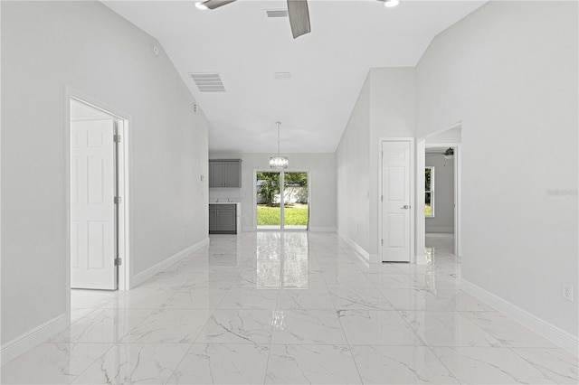 interior space featuring ceiling fan and high vaulted ceiling