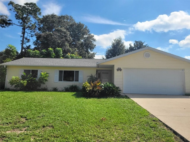 single story home featuring a garage and a front lawn