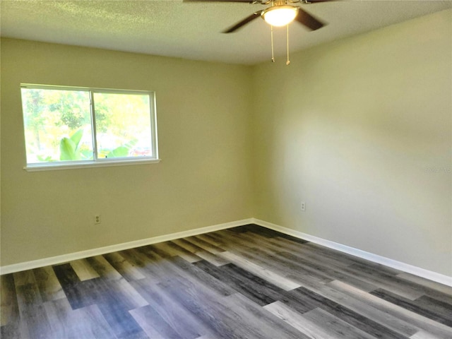 empty room with a textured ceiling, dark hardwood / wood-style floors, and ceiling fan