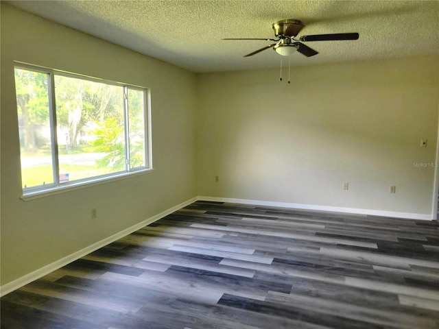 unfurnished room featuring ceiling fan, a textured ceiling, and dark wood-type flooring