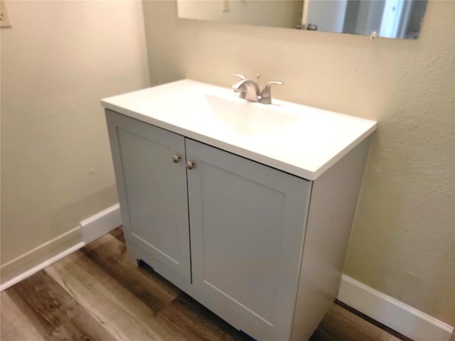 bathroom featuring vanity and hardwood / wood-style flooring