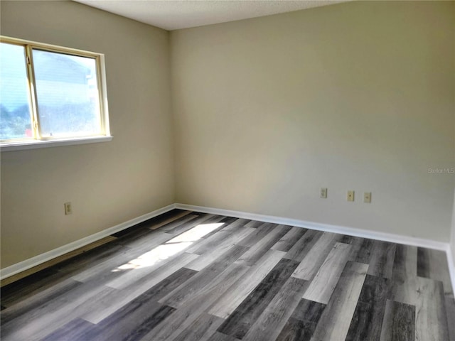 unfurnished room with dark hardwood / wood-style floors