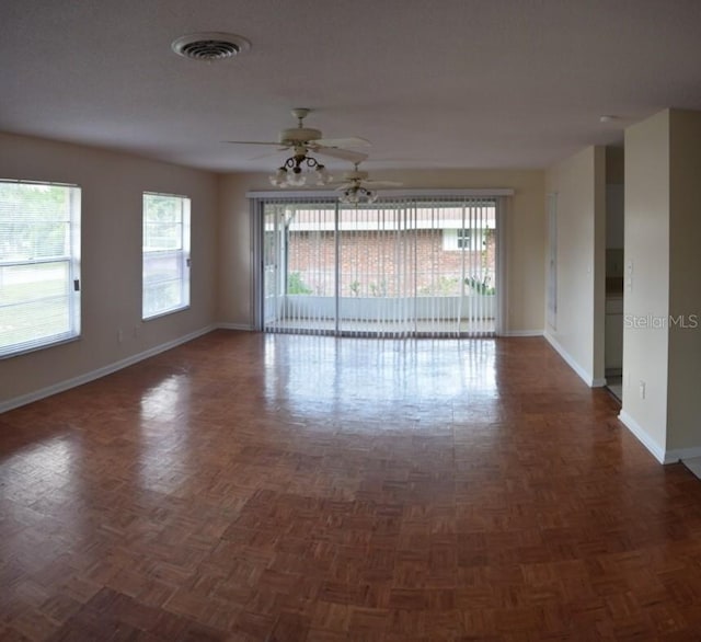 spare room featuring dark parquet floors and ceiling fan