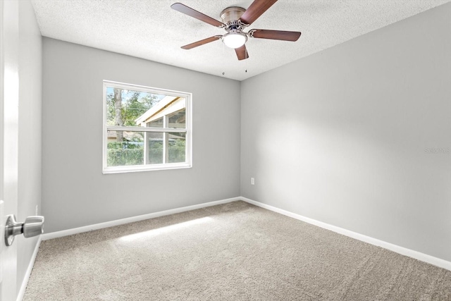 unfurnished room featuring carpet flooring, ceiling fan, and a textured ceiling