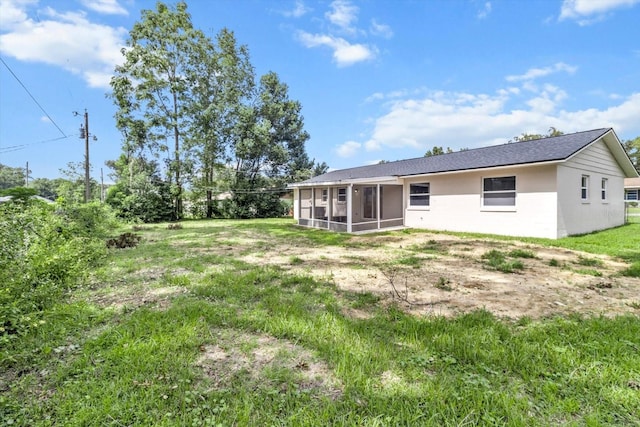 back of property with a sunroom