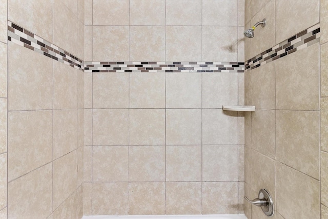 bathroom with a tile shower