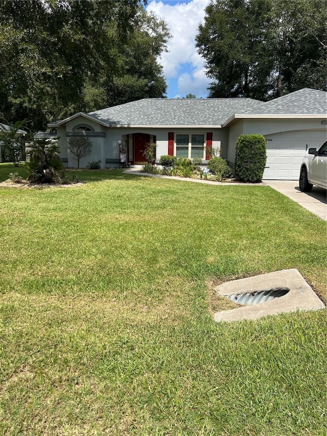 ranch-style home with a front lawn and a garage