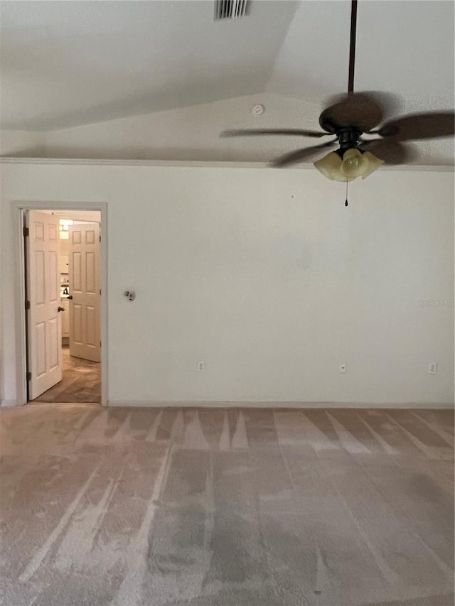 carpeted spare room with lofted ceiling and ceiling fan