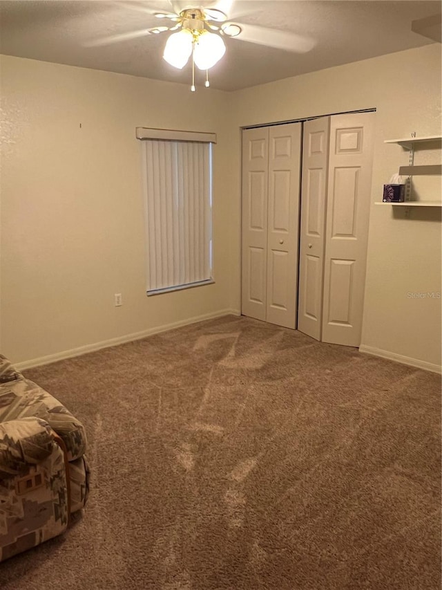 unfurnished bedroom with carpet flooring, ceiling fan, and a closet