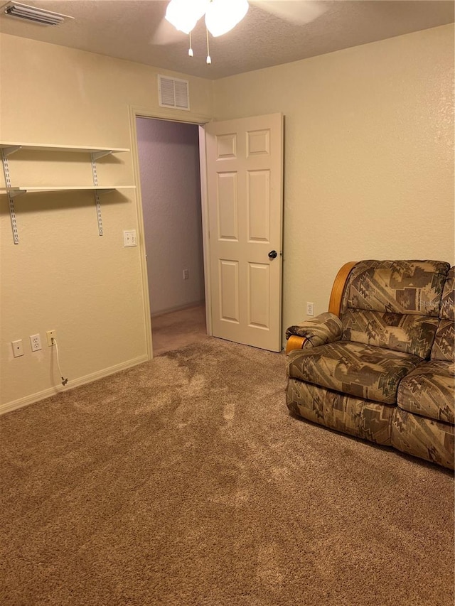 carpeted living room with ceiling fan