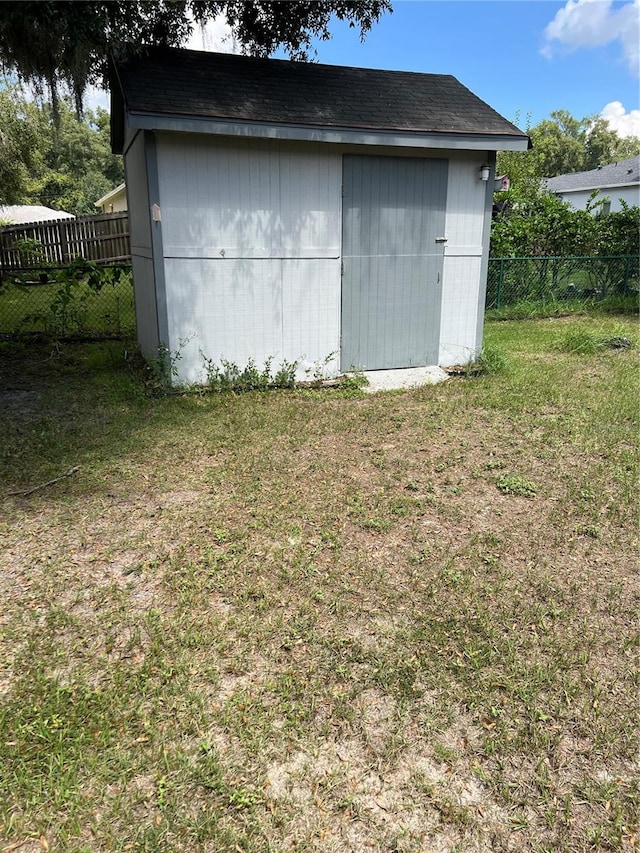 view of outdoor structure featuring a lawn