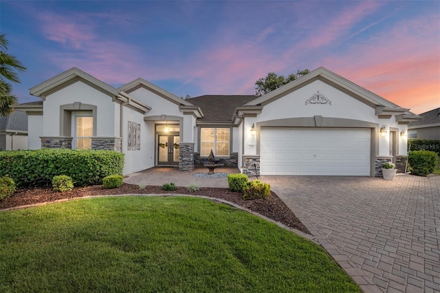 view of front of house featuring a garage and a yard