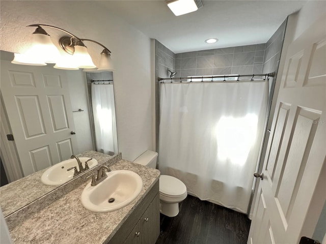 full bathroom with shower / bath combination with curtain, vanity, toilet, and hardwood / wood-style flooring