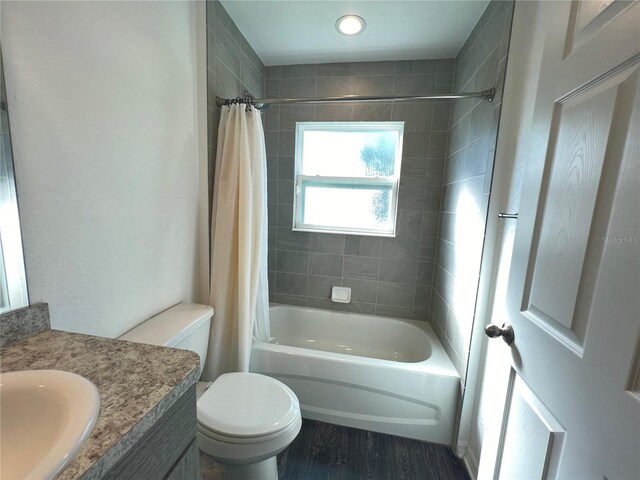 full bathroom featuring hardwood / wood-style floors, vanity, toilet, and shower / bath combination with curtain