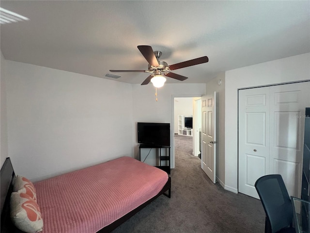 carpeted bedroom with ceiling fan and a closet