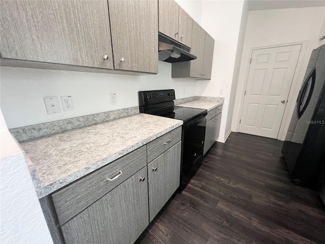 kitchen featuring fridge, black range with electric cooktop, dark wood-type flooring, and gray cabinets