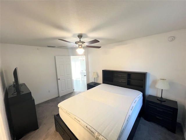 bedroom featuring ceiling fan and dark colored carpet