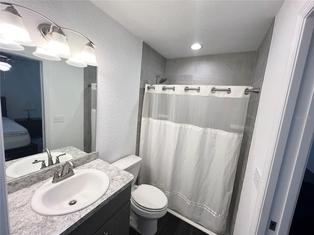 bathroom with a shower with shower curtain, vanity, and toilet