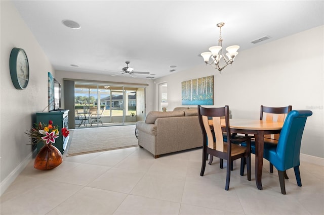 dining room featuring ceiling fan with notable chandelier and light tile patterned flooring