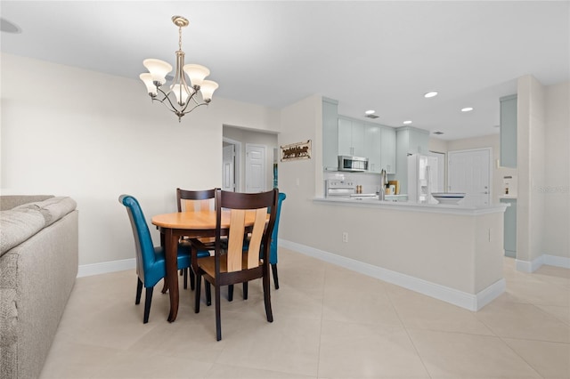 tiled dining area featuring a chandelier