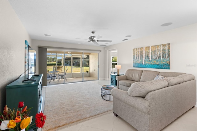 living room with ceiling fan and light tile patterned flooring