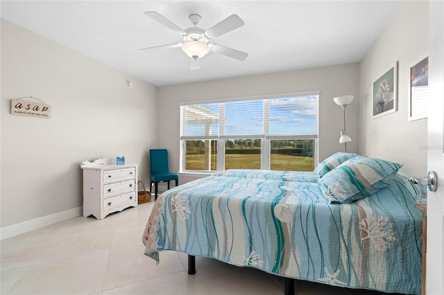 tiled bedroom featuring ceiling fan