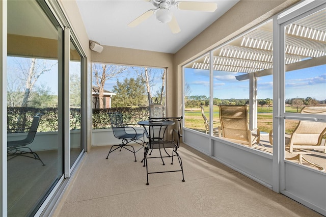 sunroom / solarium featuring ceiling fan