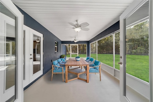 sunroom / solarium featuring plenty of natural light and ceiling fan