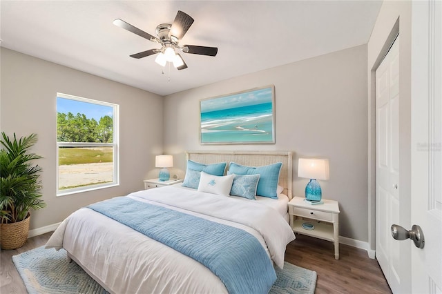 bedroom with hardwood / wood-style floors, a closet, and ceiling fan