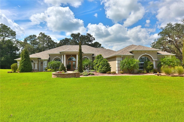 mediterranean / spanish house with a front lawn