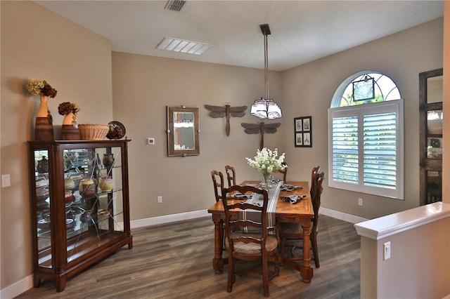 dining room with a chandelier and dark hardwood / wood-style flooring