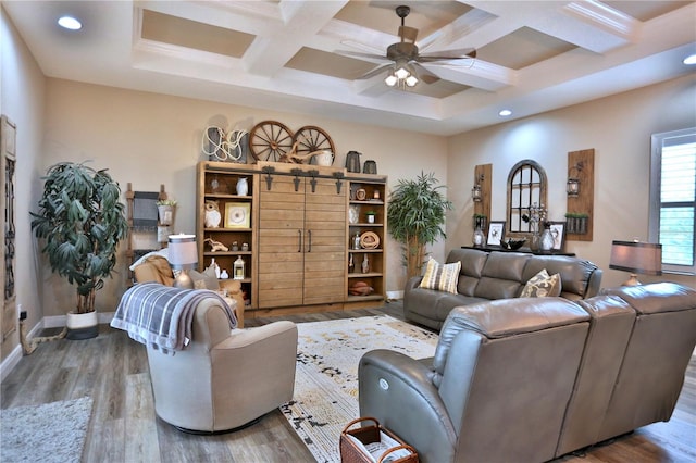 living room with wood-type flooring, beam ceiling, coffered ceiling, and ceiling fan