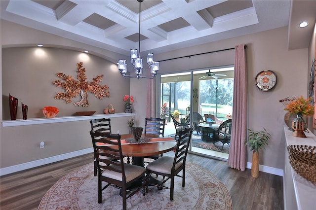 dining space featuring ceiling fan with notable chandelier, dark wood-type flooring, and crown molding