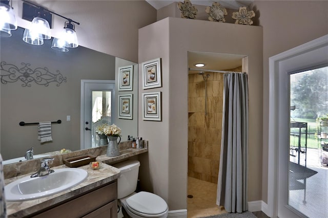 bathroom featuring a shower with shower curtain, vanity, and toilet