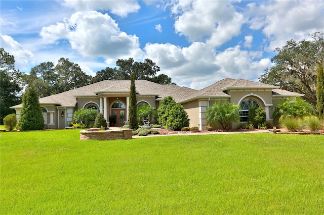 mediterranean / spanish-style home with a front lawn