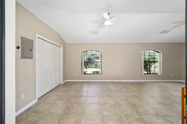 unfurnished bedroom with ceiling fan, light tile patterned floors, multiple windows, and electric panel